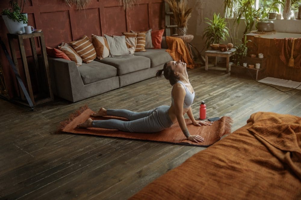 Attractive,Young,Woman,Holding,A,Cobra,Pose,While,Doing,Yoga
