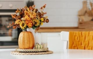 Still-life.,Yellow,,Orange,Flowers,In,A,Vase,,Pumpkins,And,Candles