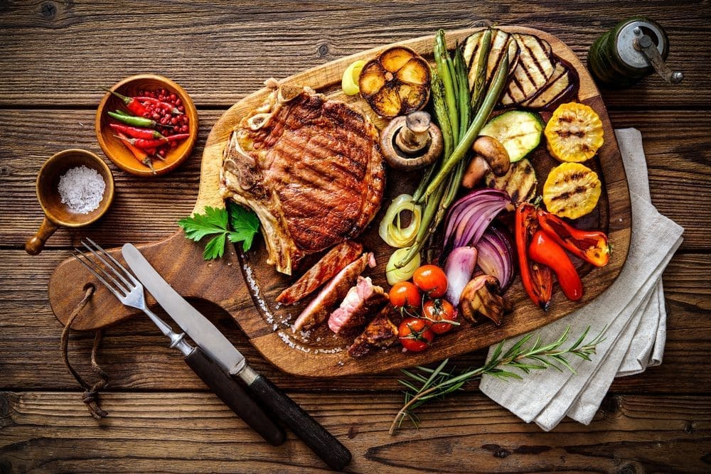 Beef,Steak,With,Grilled,Vegetables,And,Seasoning,On,Serving,Board