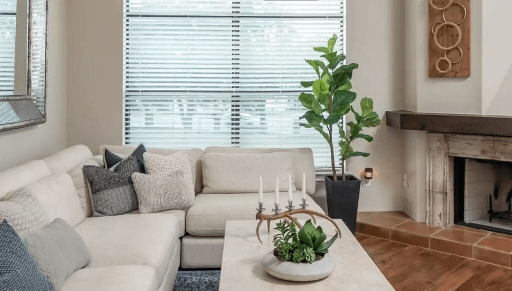 Elegant and cozy living room interior at Landmark Lofts in New Braunfels, Texas, featuring a comfortable sectional sofa, stylish fireplace, and modern decor.